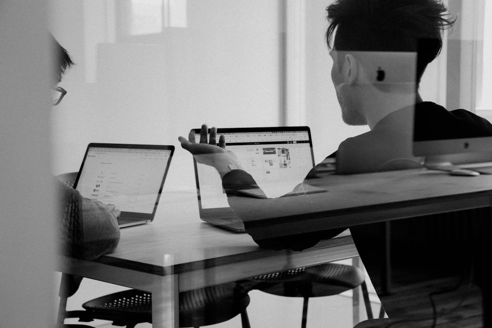 Colleagues reviewing a project on laptops